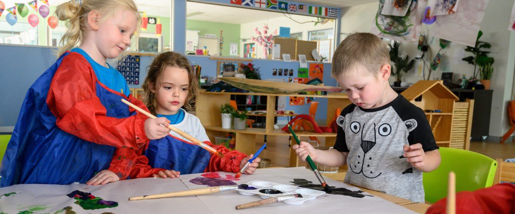 Children painting at table