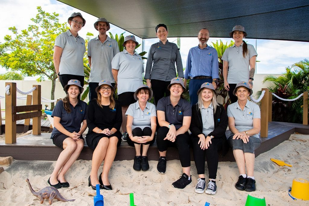 childcare team sitting in sandpit