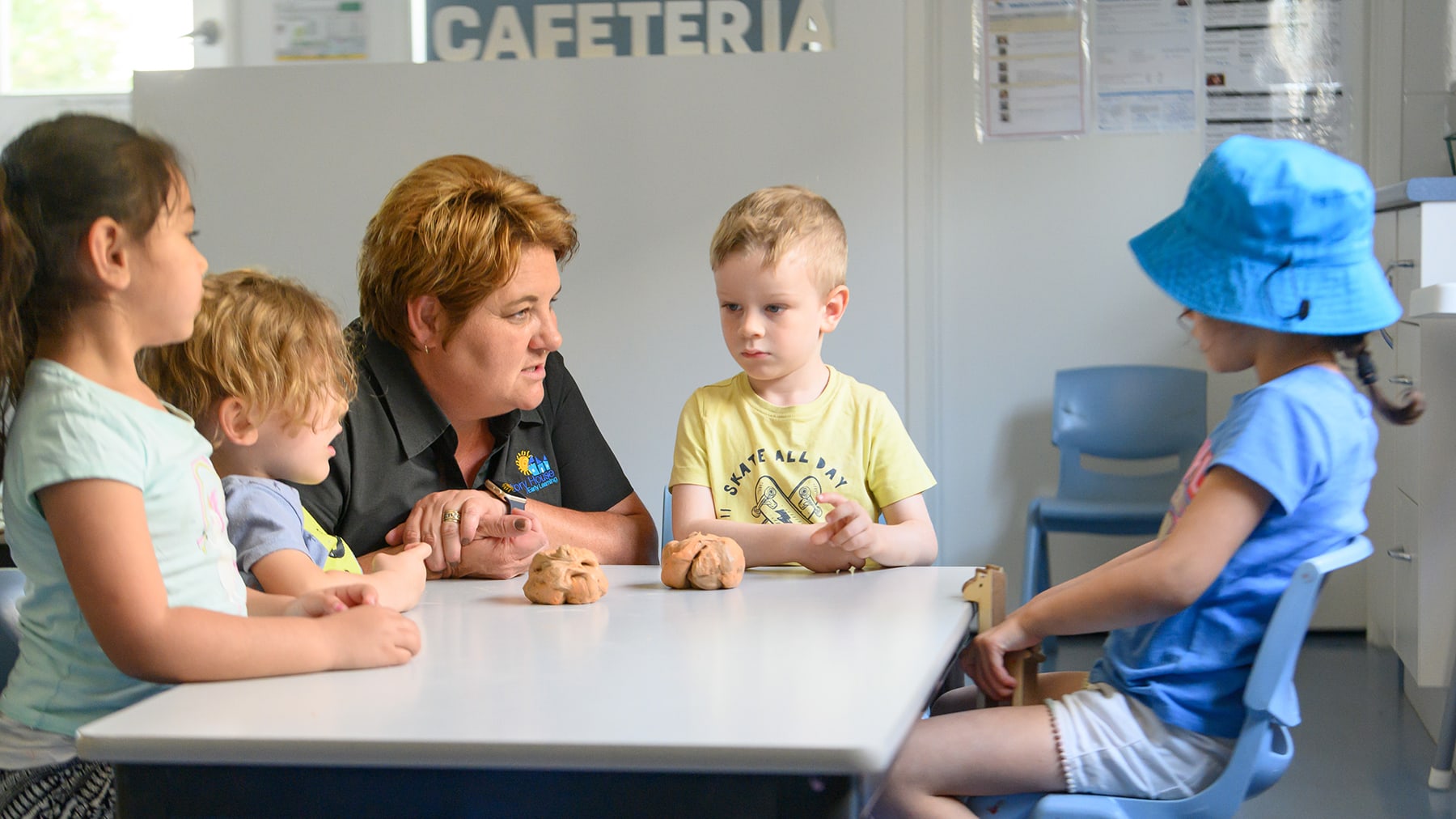 Childcare instructor listening to children