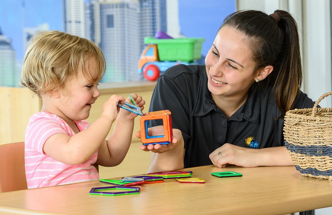 childcare worker playing with child