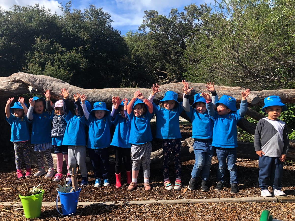 Kinder kids posing for a photo outdoors
