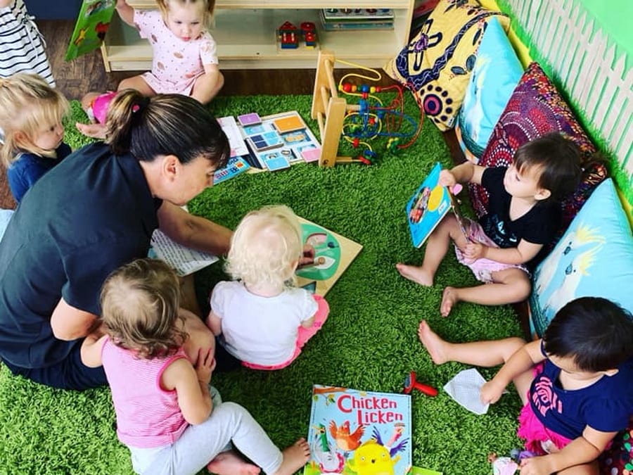 Instructor teaching children how to paint